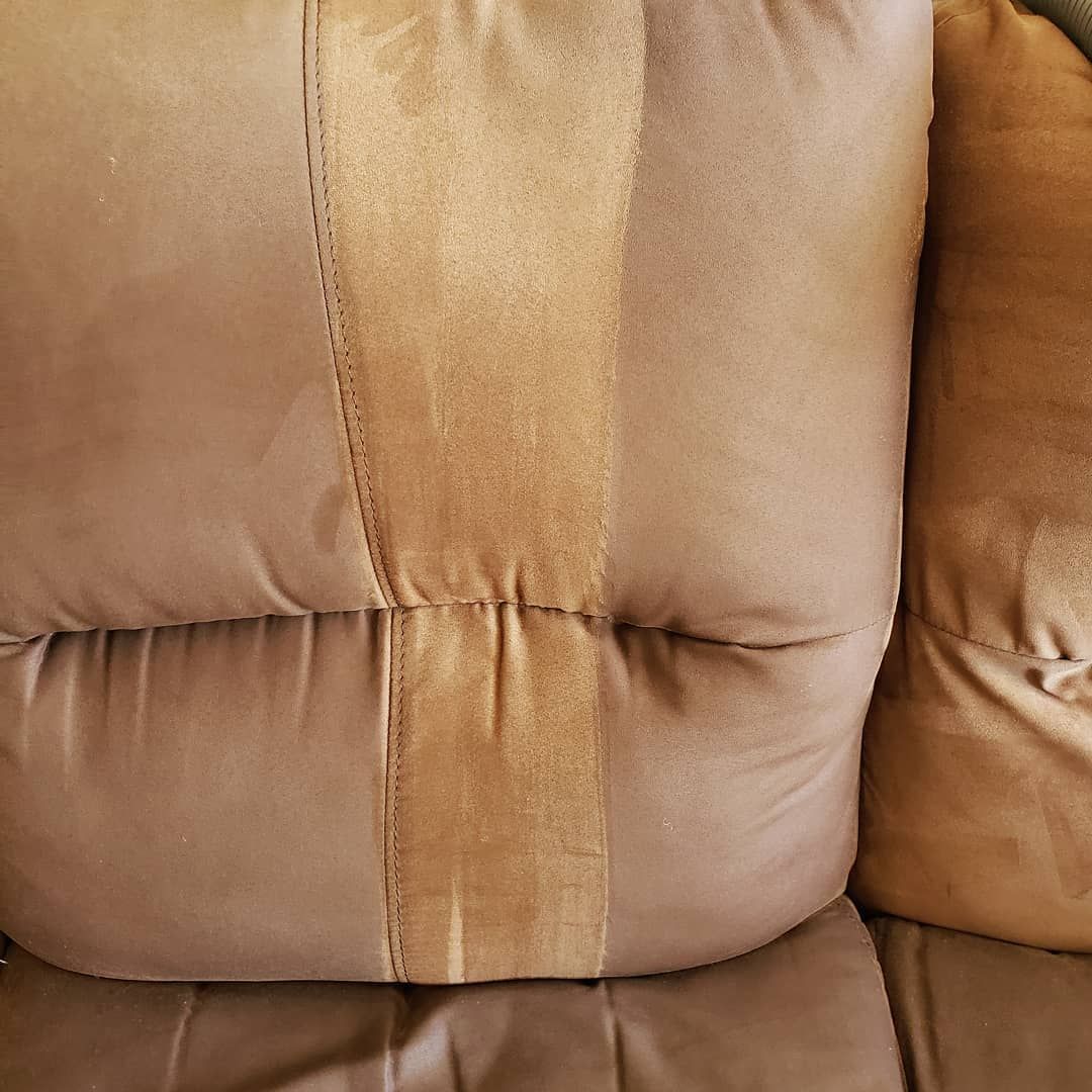 A close up of a brown pillow on a couch