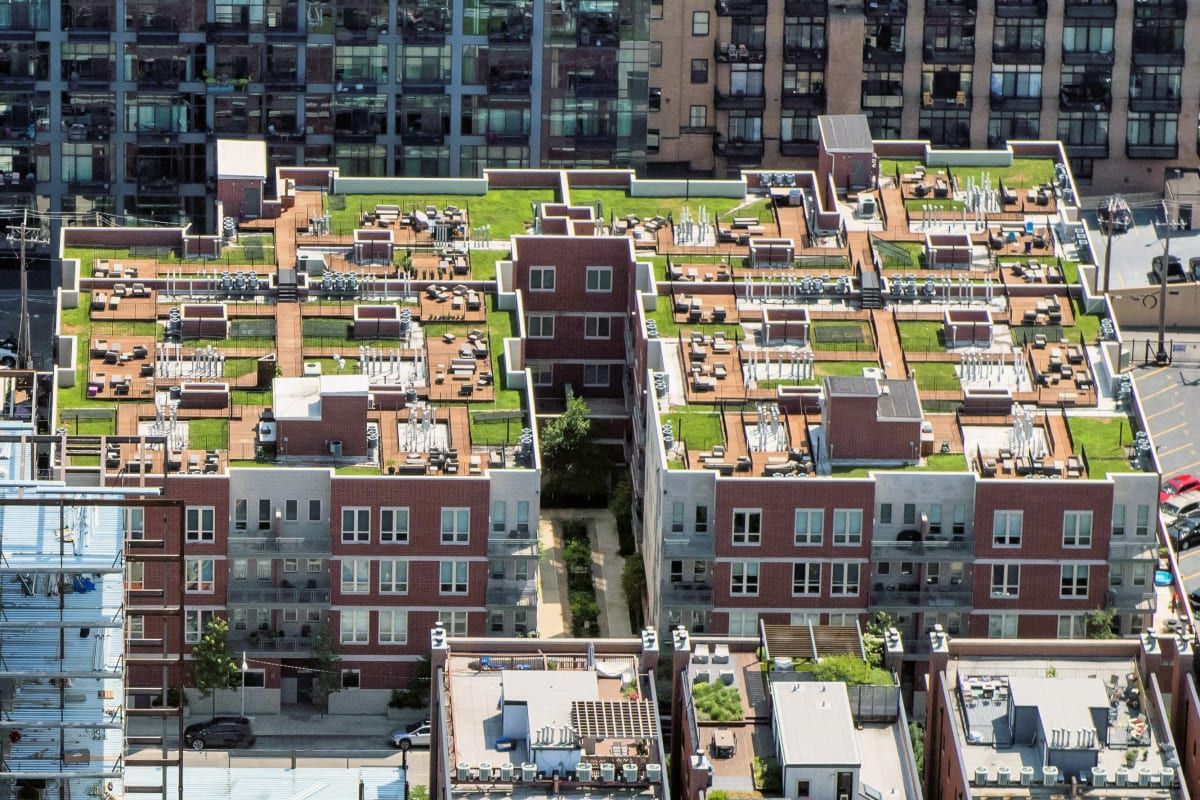 An aerial view of a large apartment building with a green roof at Reside on Jackson.