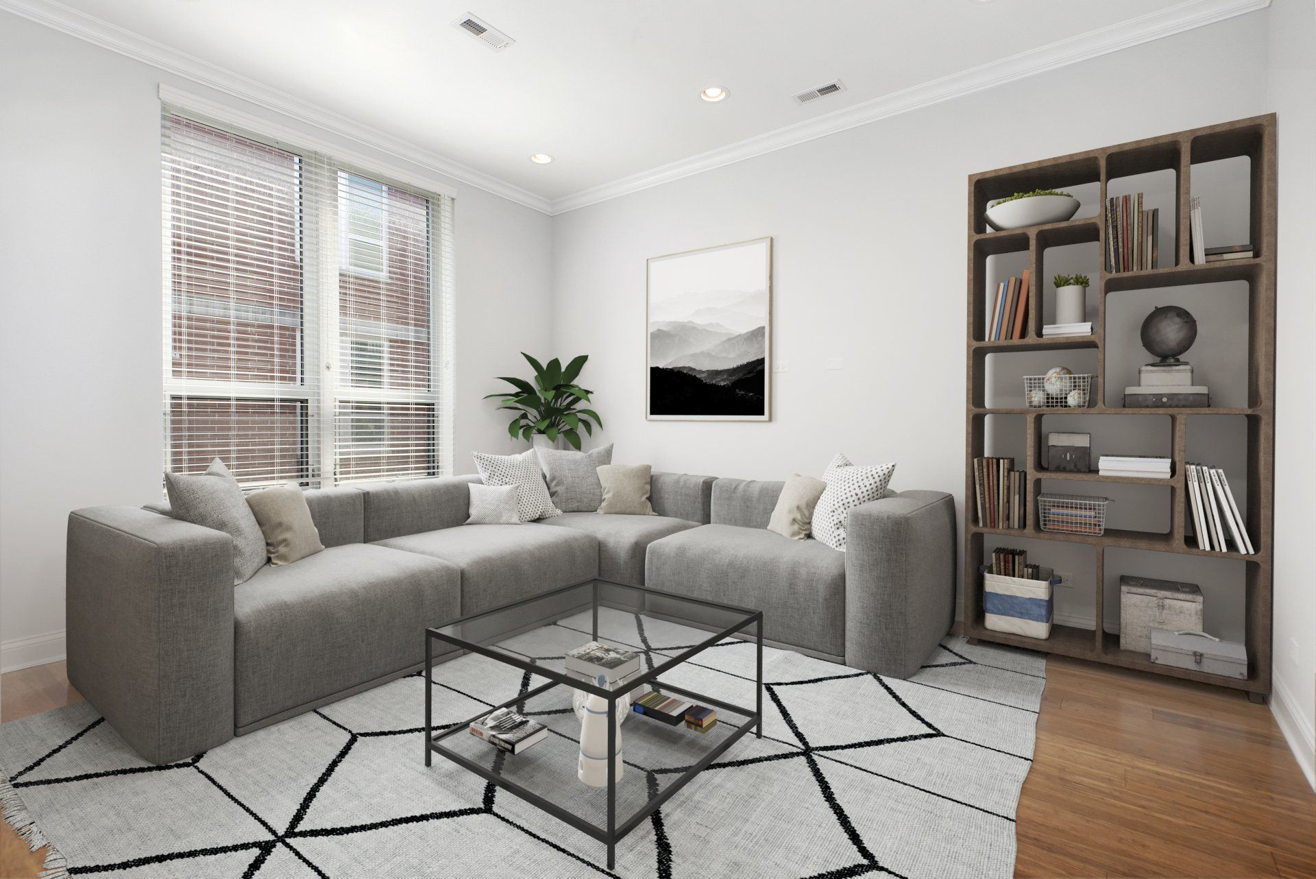 A living room with two couches, a coffee table, and a bookshelf at Reside on Jackson.