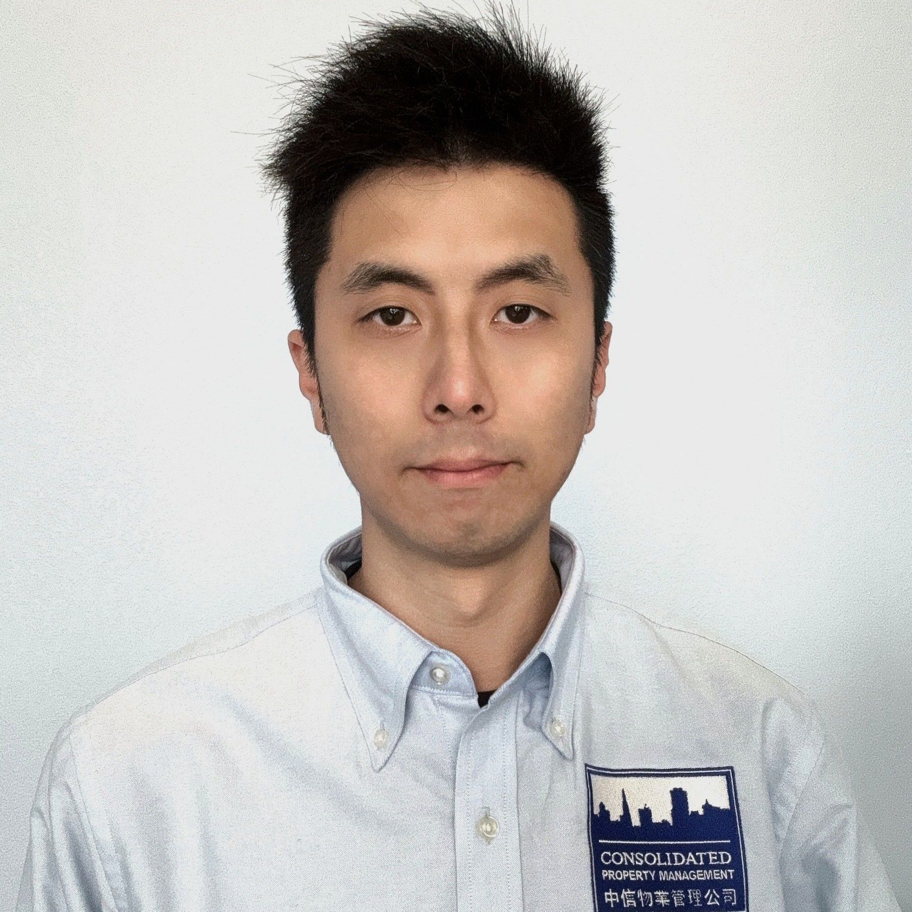A man wearing a blue shirt with a city on it
