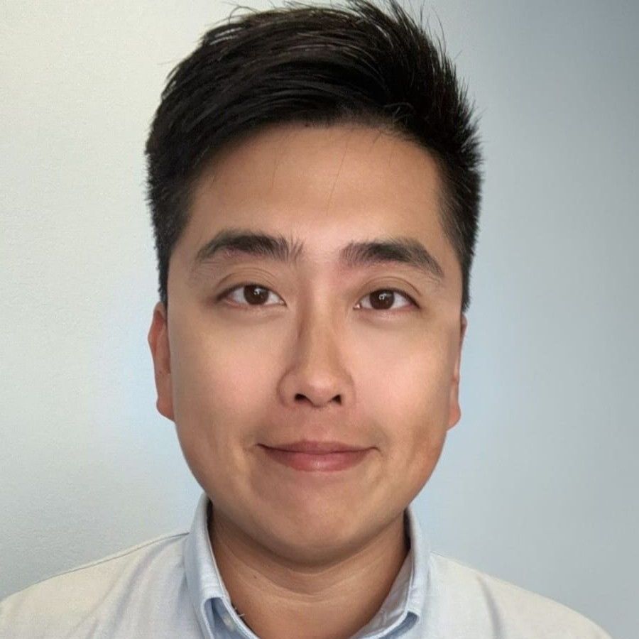 A close up of a man 's face with a smile on his face.