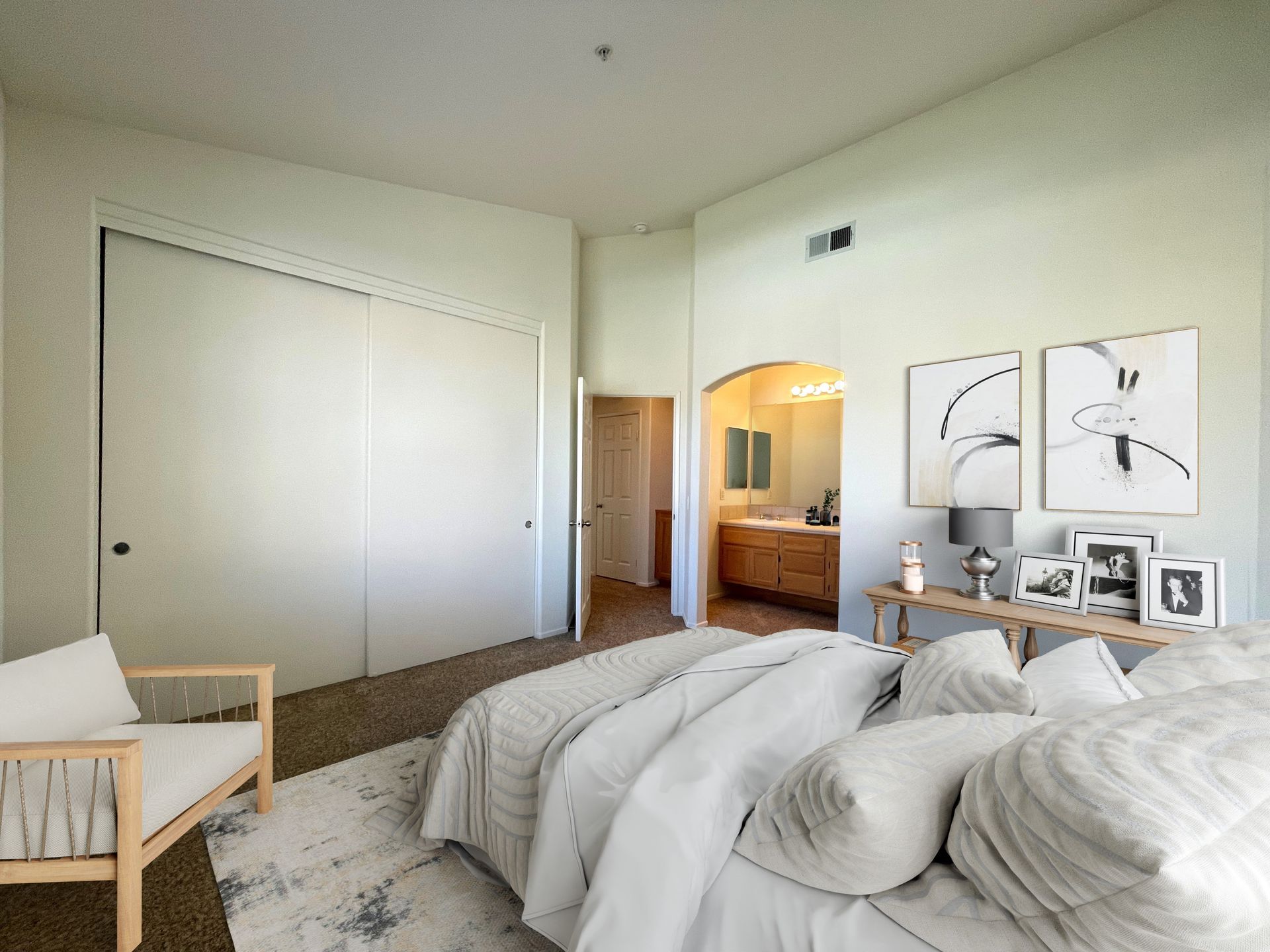 A bedroom with a large bed , chair , and closet.