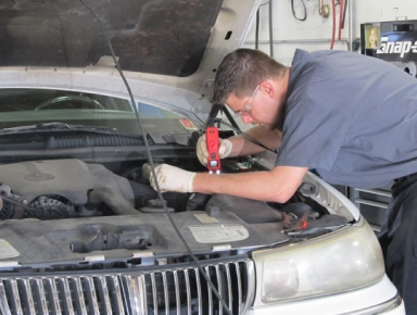 Our Certified Mechanic Checking Engine in Glen Burnie, MD - Maryland Auto & Truck Repair