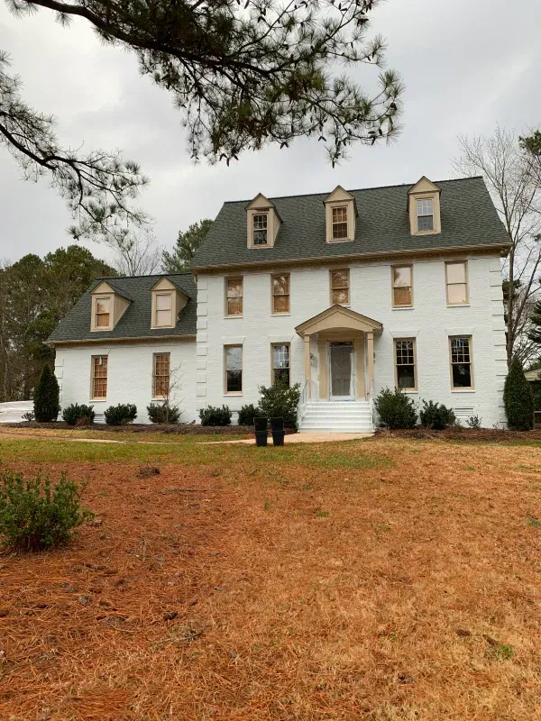 A large white house with a black roof