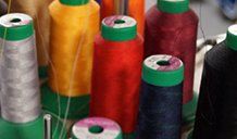 Large spools of embroidery thread several colors