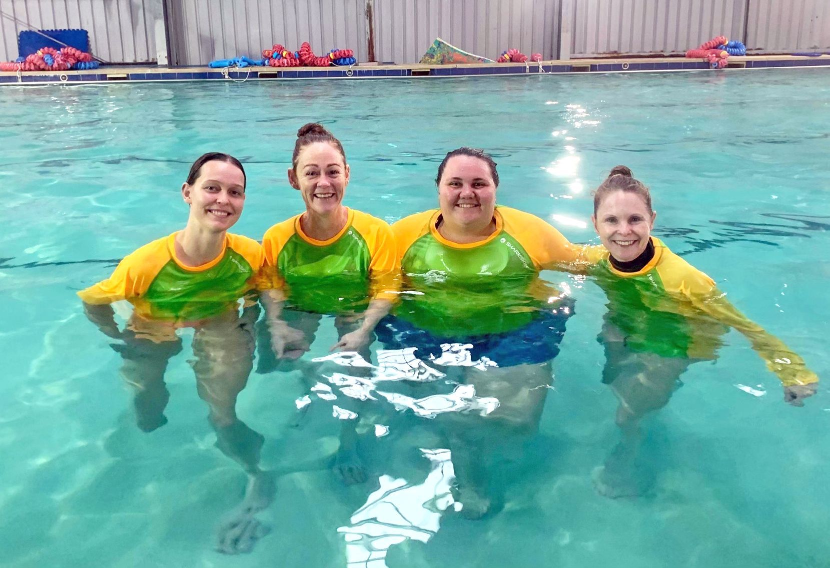 A group of women are posing for a picture in a swimming pool-Swim School In Valentine, NSW