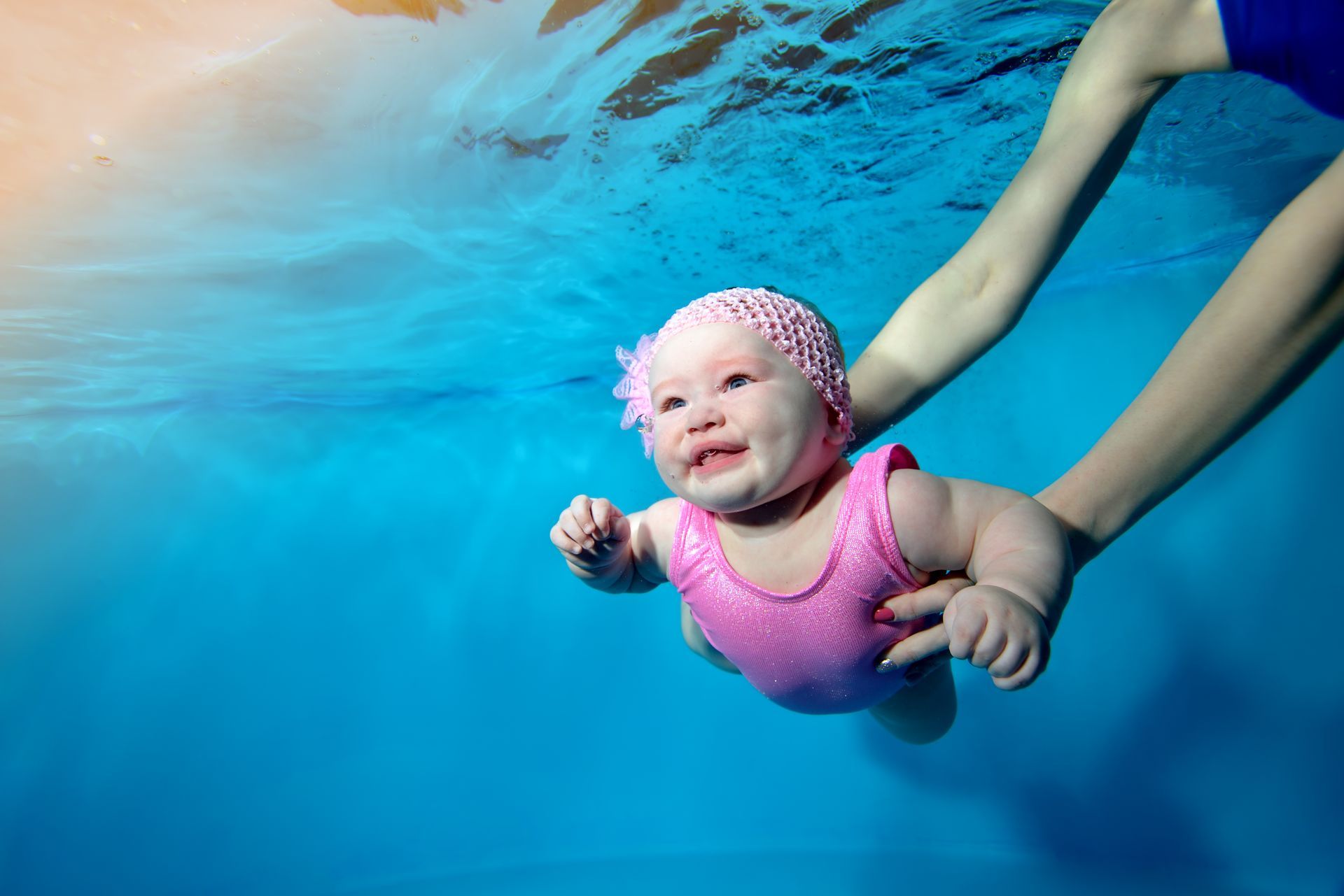 A baby is swimming underwater in a swimming pool-Swim School In Valentine, NSW