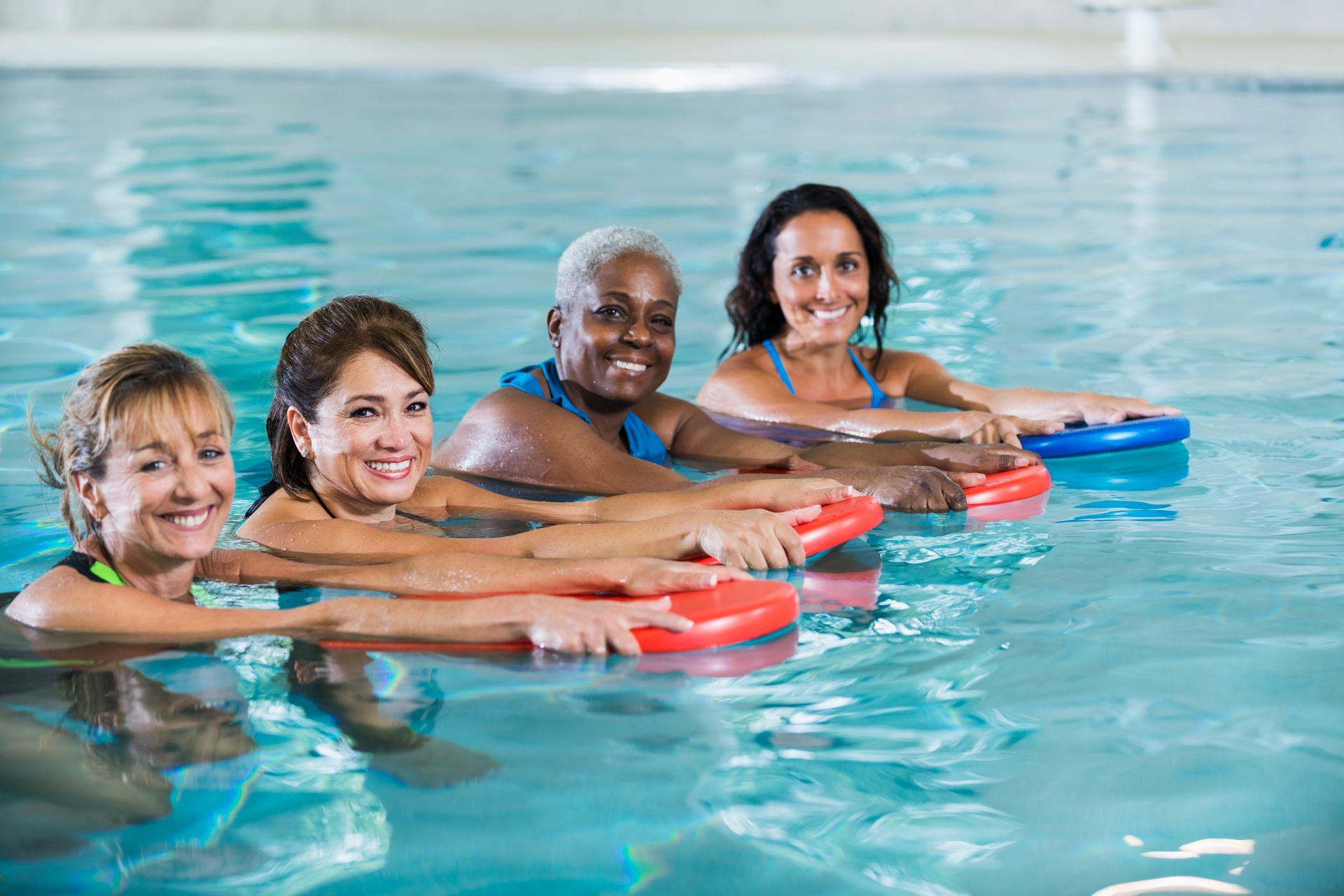 A group of women are doing aqua aerobics in a swimming pool-Swim School In Valentine, NSW