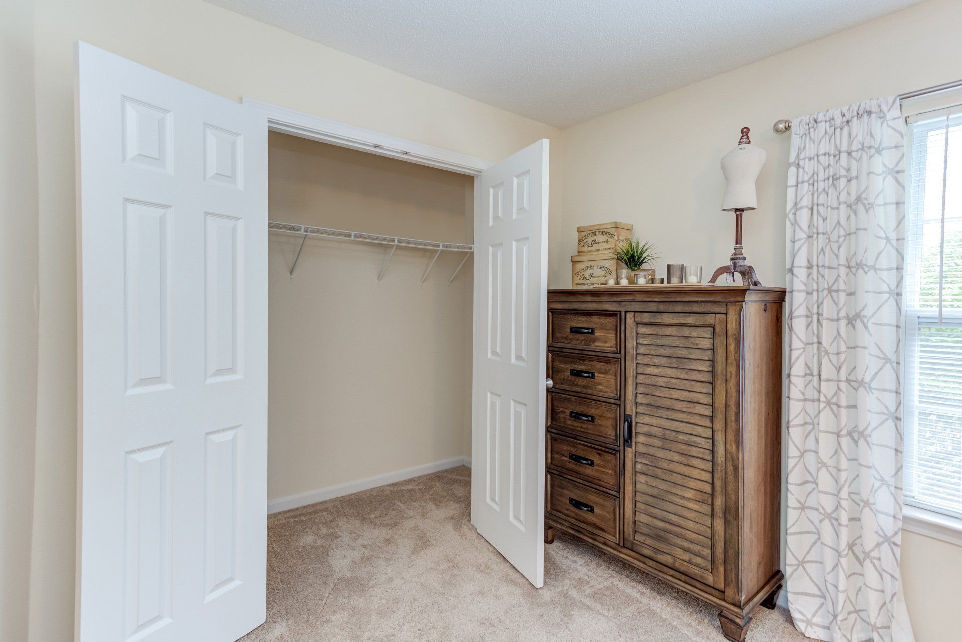 A bedroom with a walk-in closet and a dresser at Morgan Ridge.