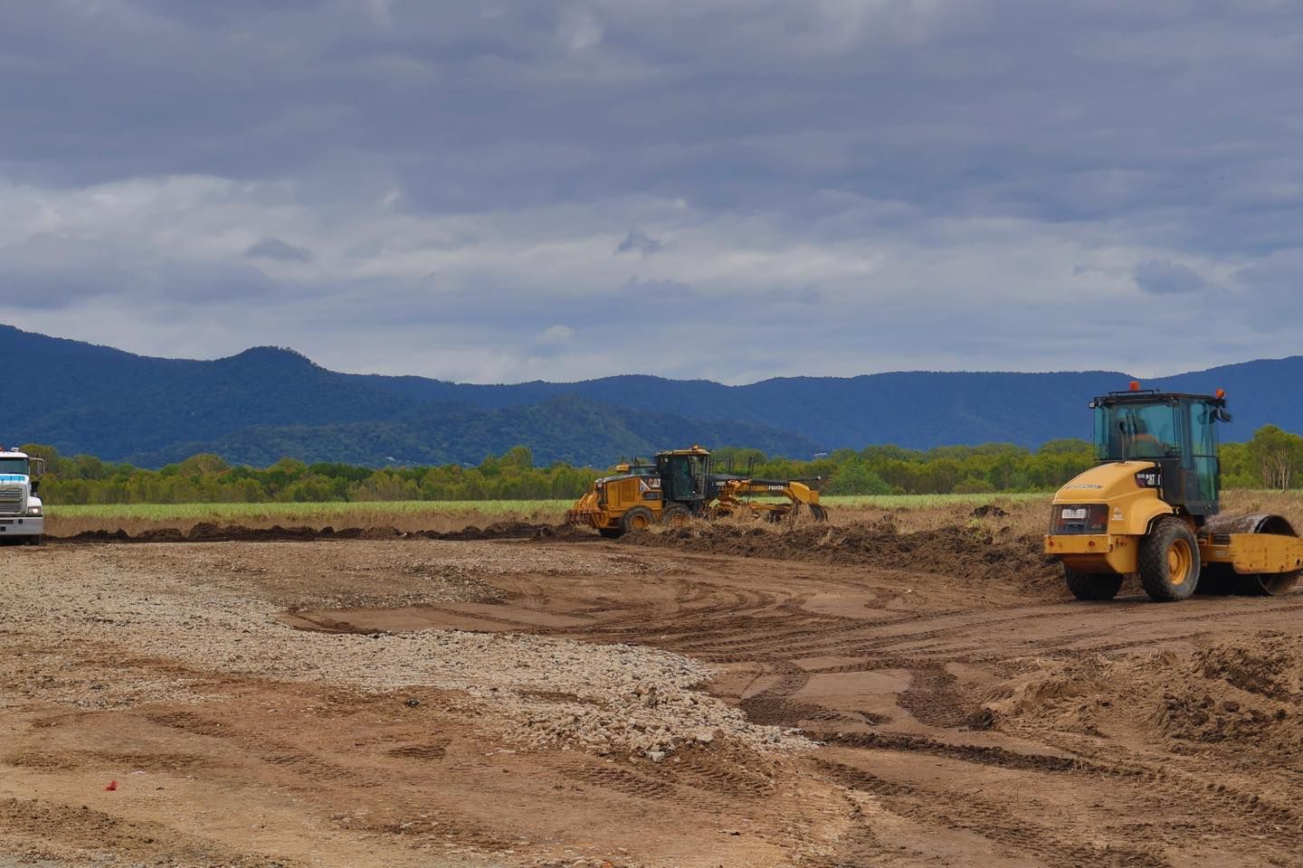 A Construction Site With Mountains in the Background and a Truck in the Foreground — Advanced Civil Earthworks In Koah, QLD