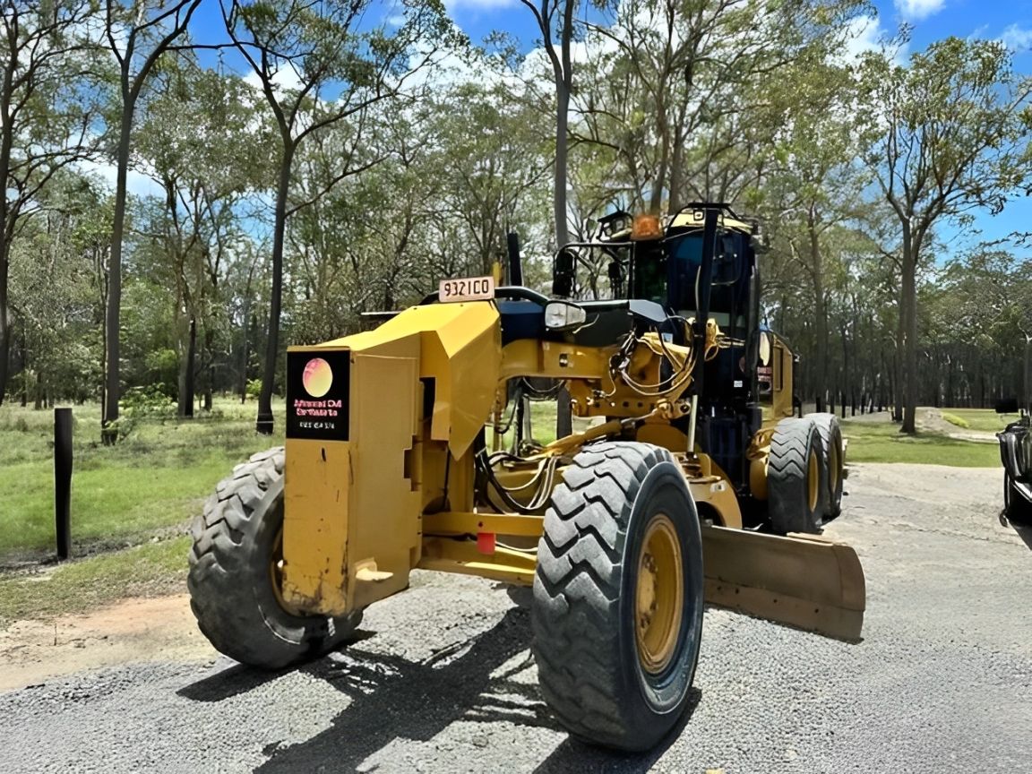 A yellow tractor is parked on the side of the road — Advanced Civil Earthworks In Koah, QLD