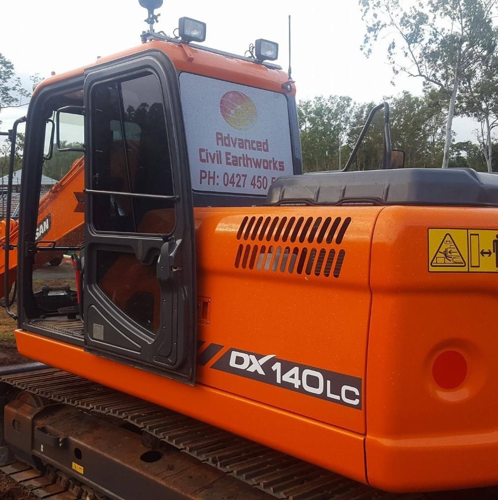 An Orange Doosan Excavator is Parked in a Field — Advanced Civil Earthworks In Cooktown, QLD