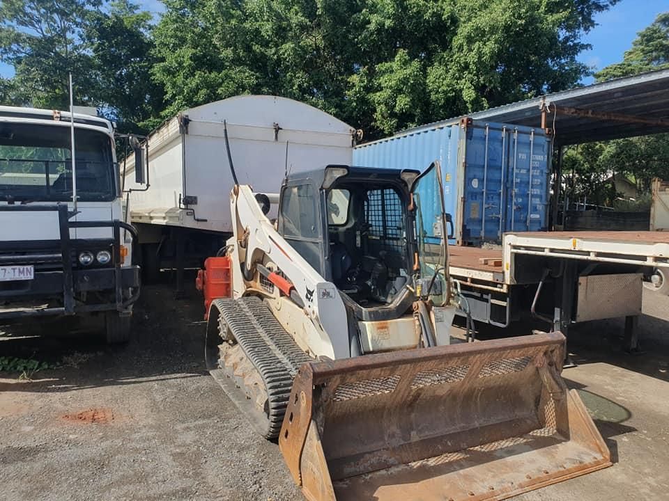A Bulldozer is Parked Next to a Dump Truck in a Parking Lot — Advanced Civil Earthworks In Cooktown, QLD