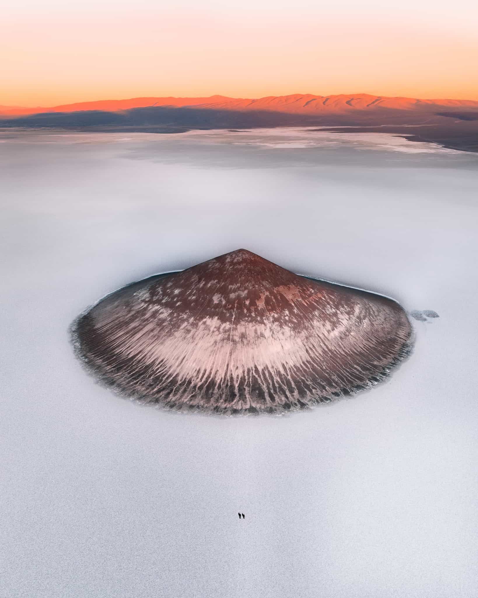 An aerial view of a small island in the middle of a lake.
