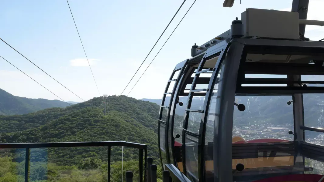A cable car is going up a mountain.