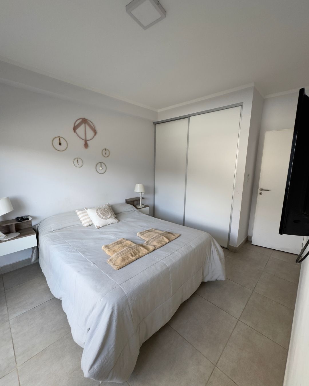 A bedroom with a large bed and a television