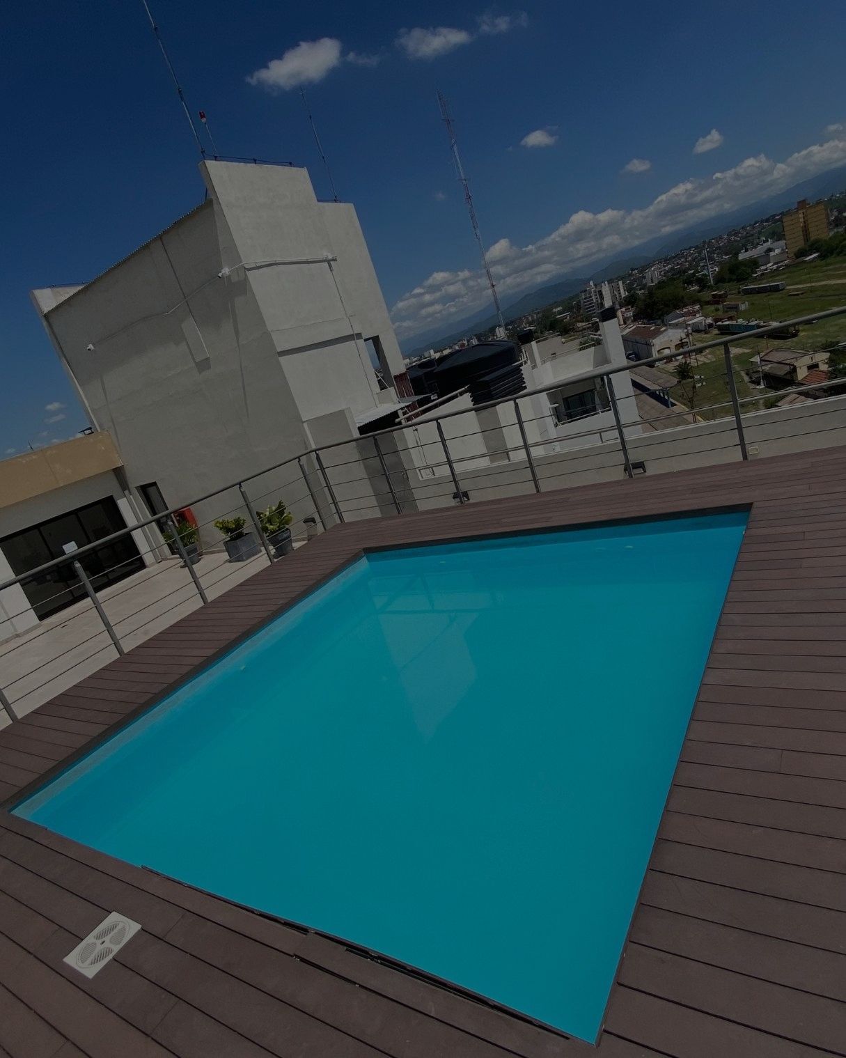 A large swimming pool on the roof of a building