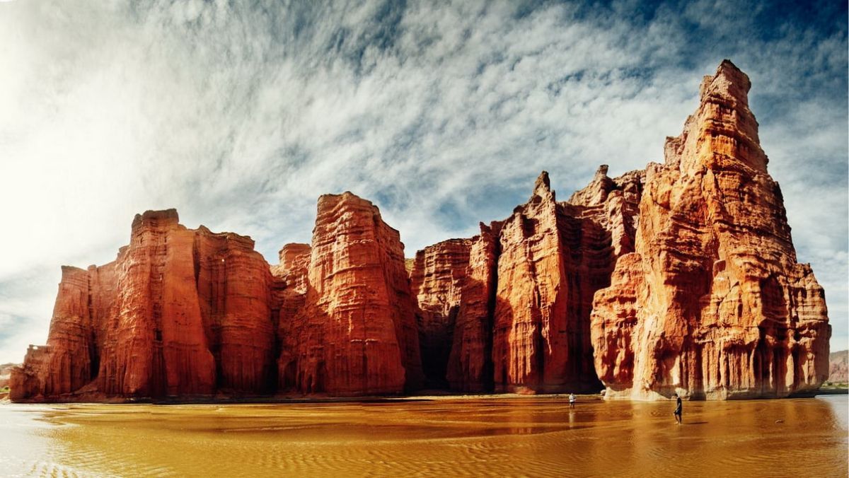 A large rock formation in the middle of a body of water.