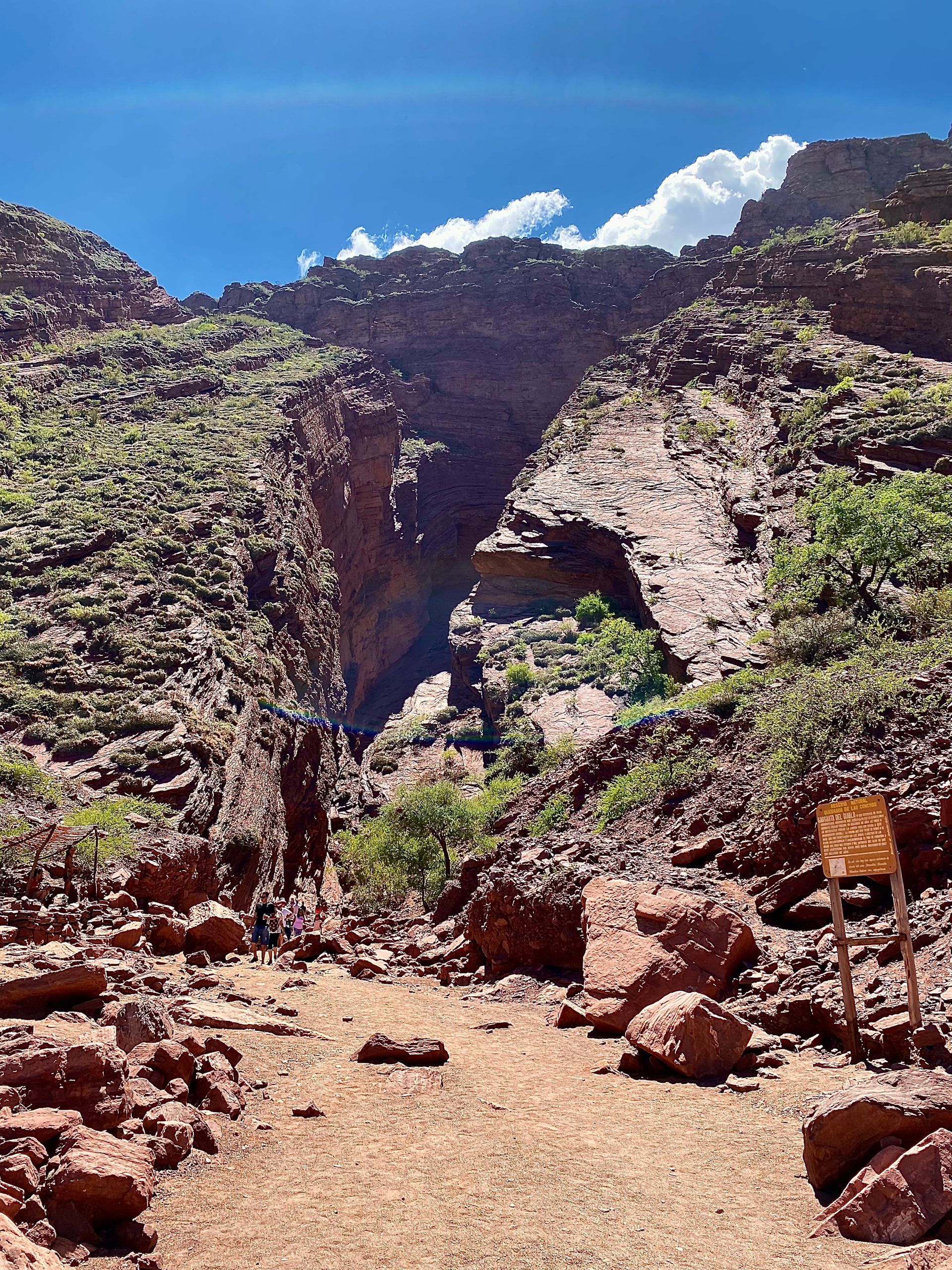 A dirt road leading to a cave in the mountains