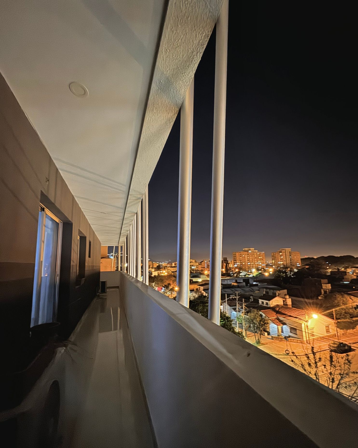 A balcony with a view of a city at night