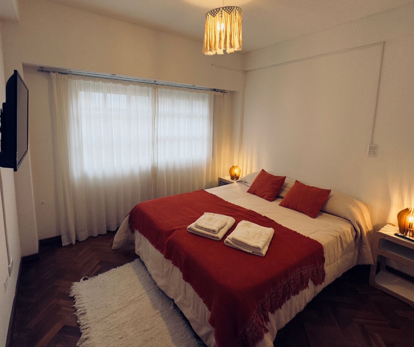 A bedroom with a large bed and a television