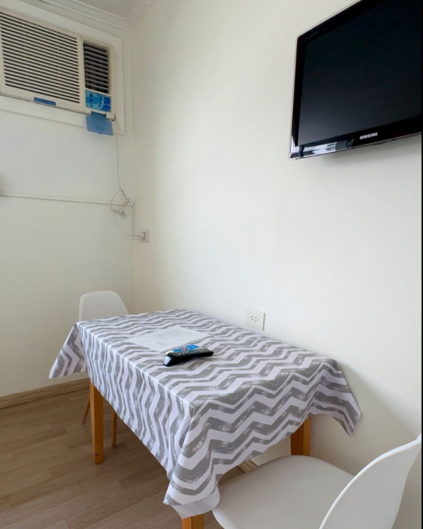 A room with a table and chairs and a flat screen tv