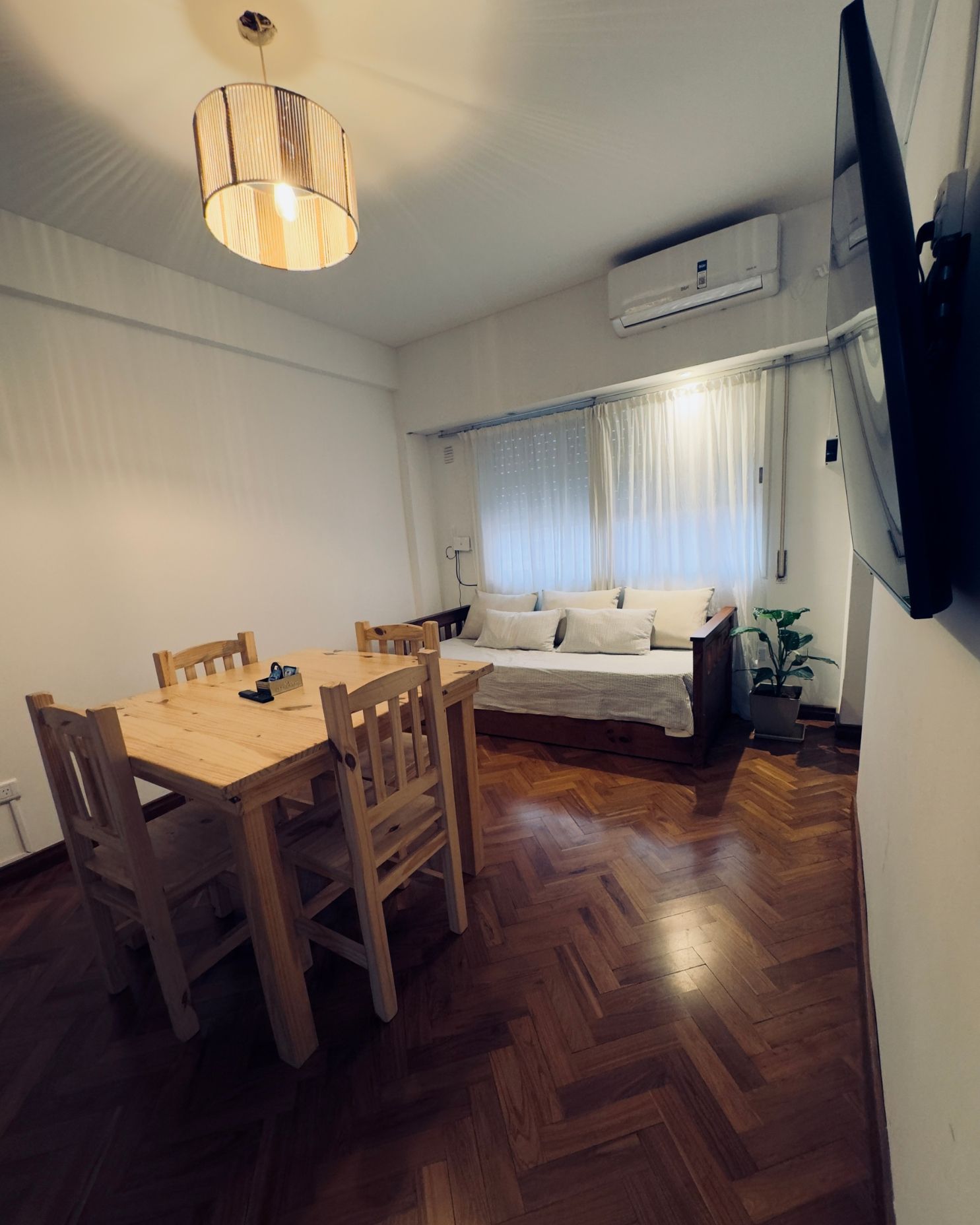 A living room with a table and chairs and a couch