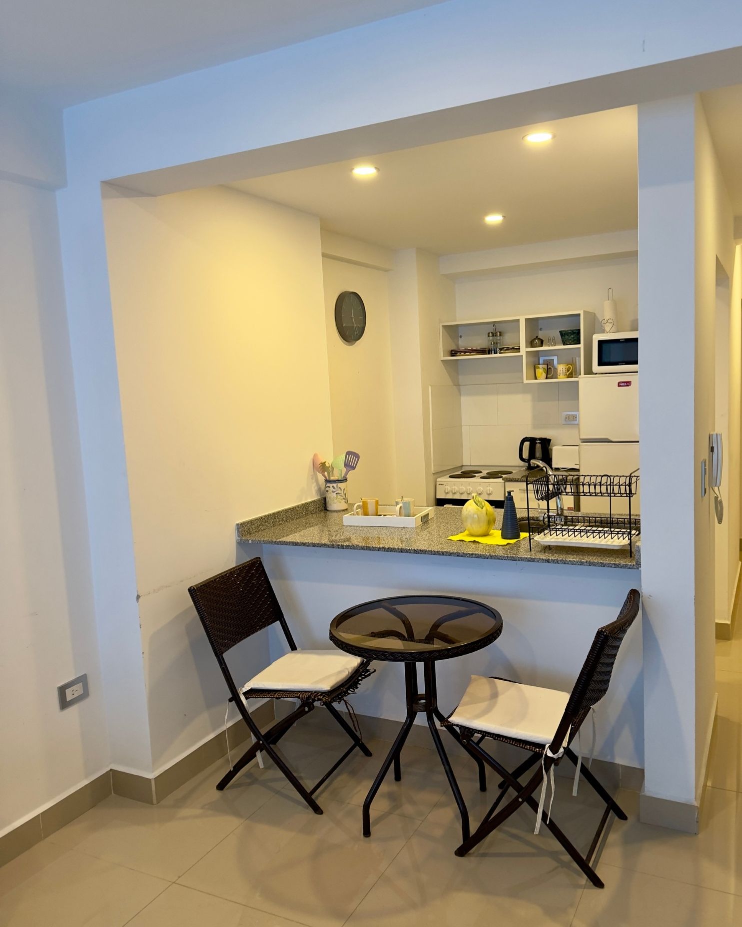 A kitchen with a table and chairs in it