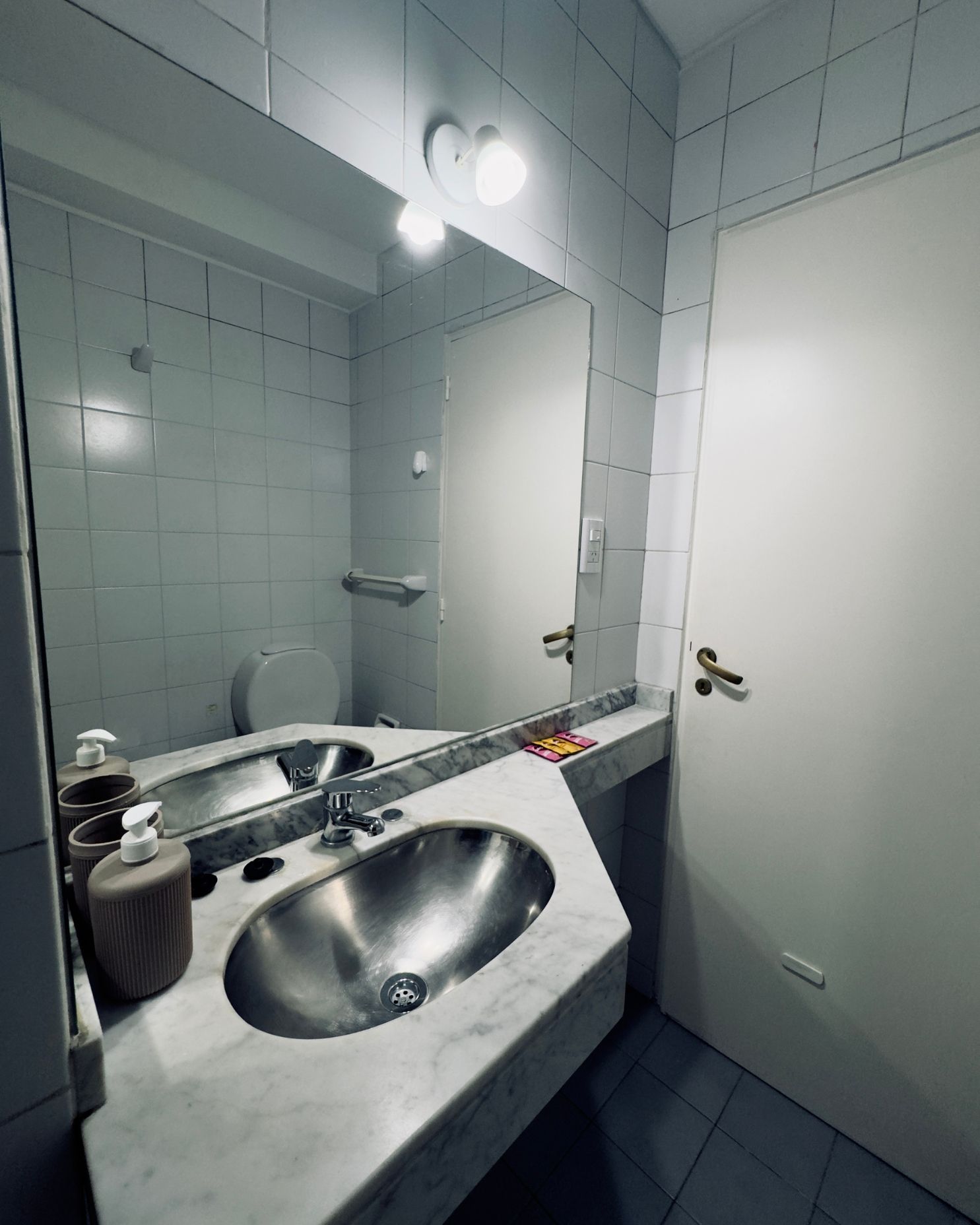 A bathroom with two sinks and a large mirror