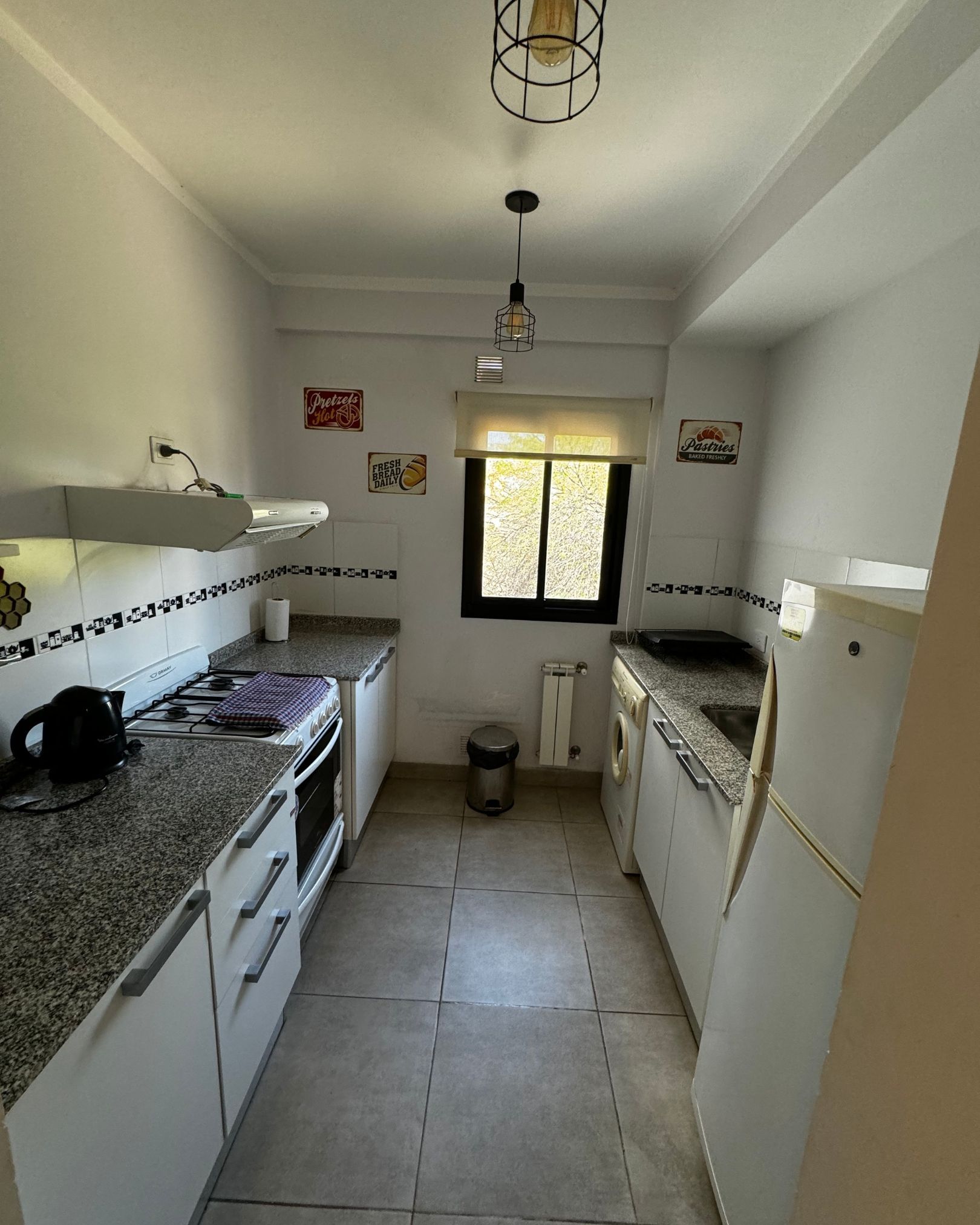 A kitchen with granite counter tops and white cabinets