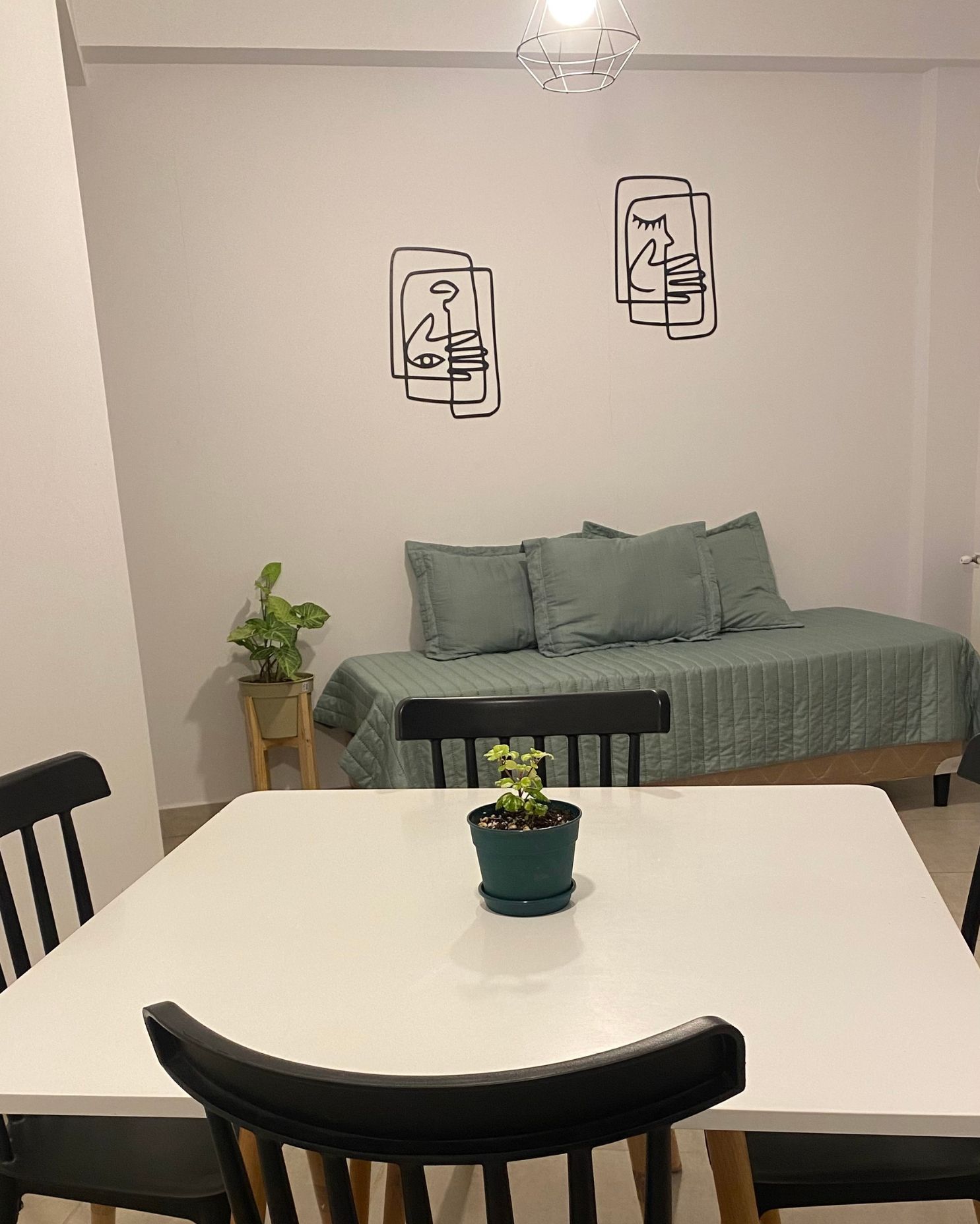A living room with a dining table and chairs and a couch.
