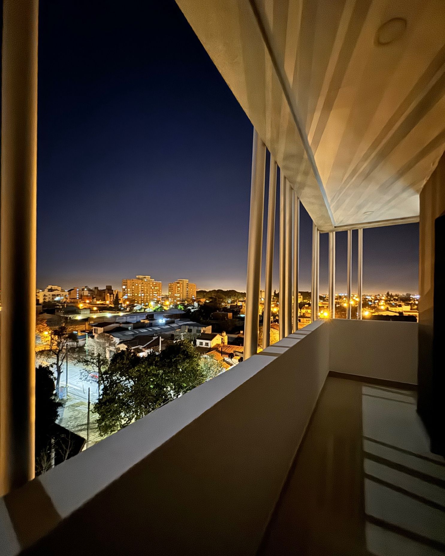A balcony with a view of a city at night