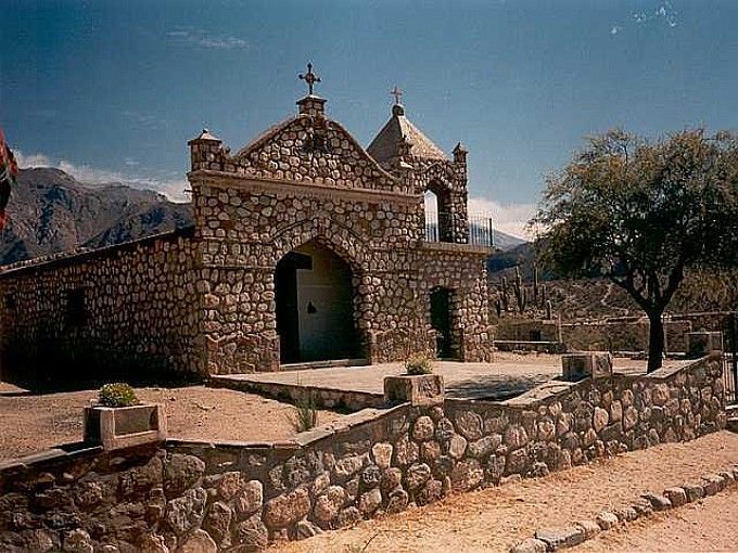 A stone building with a cross on top of it