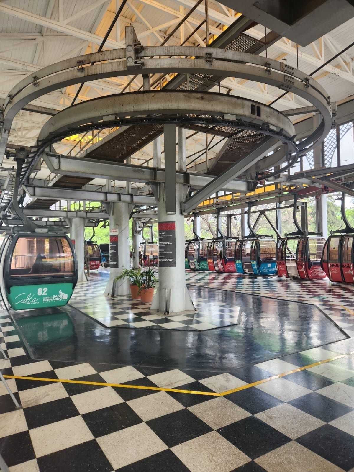 A cable car station with a checkered floor and a ceiling.