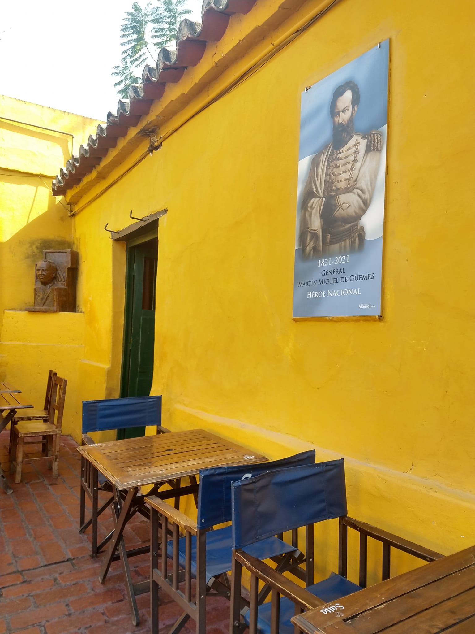 A yellow wall with a picture of a man on it