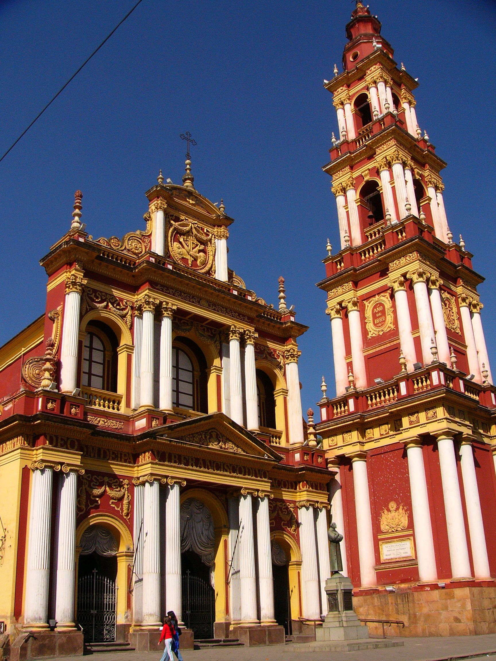 A large red and yellow building with a clock tower