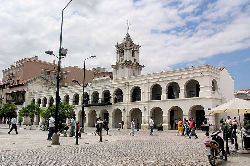 A large white building with arches and a clock tower