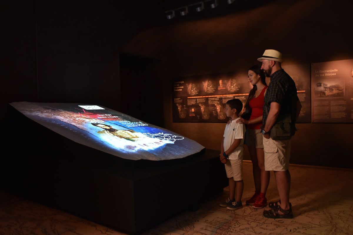A family is looking at a large screen in a museum.