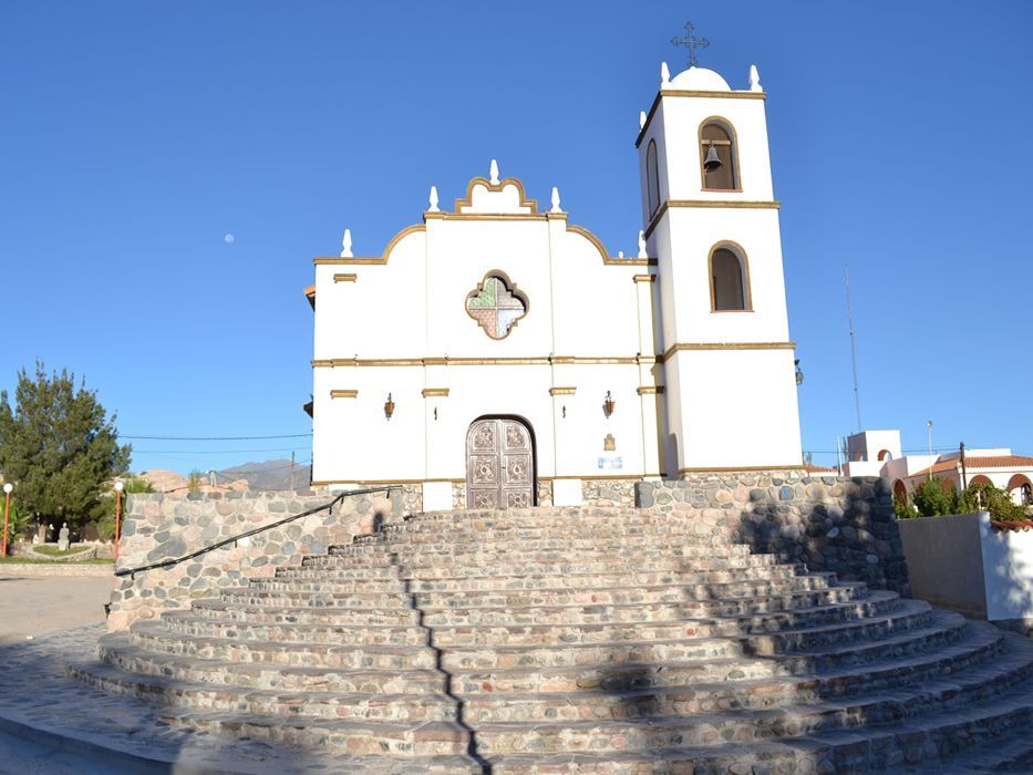 A white church with stairs leading up to it