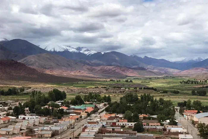 An aerial view of a small town with mountains in the background