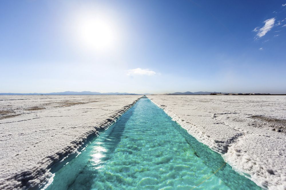 A stream of water is running through a desert.