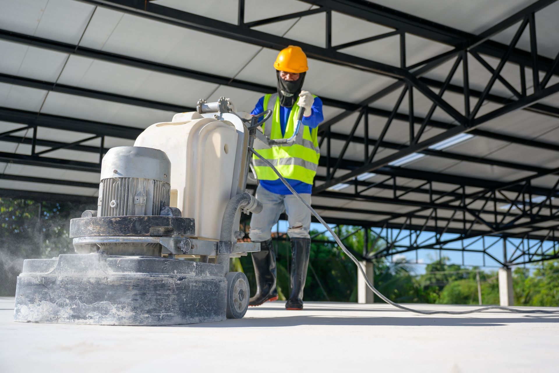 construction workers use concrete floor polishers