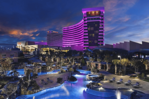 A large purple building with a swimming pool in front of it.