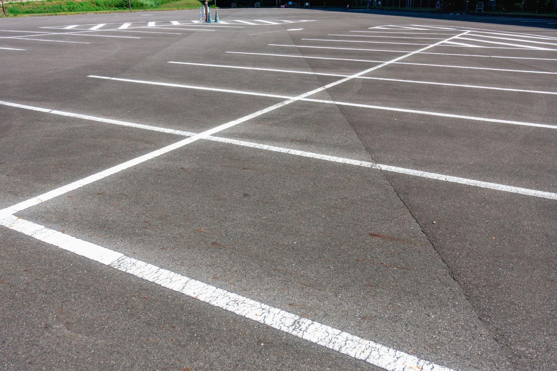 A man is cleaning a driveway in front of a house.