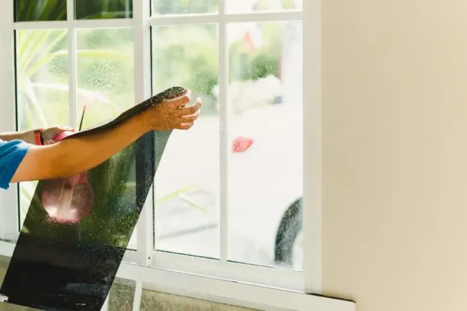 Applying solar control film to a residential glass window