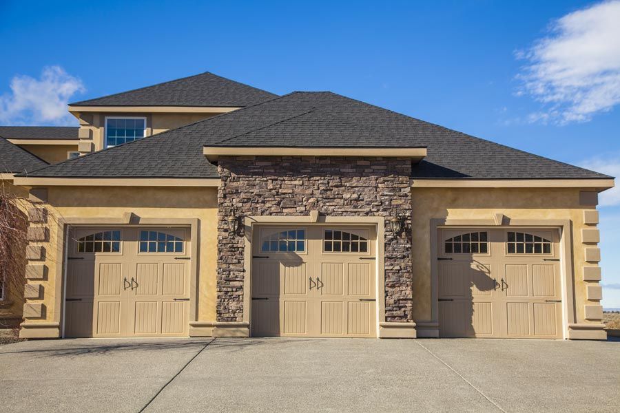 house with three brown garage doors