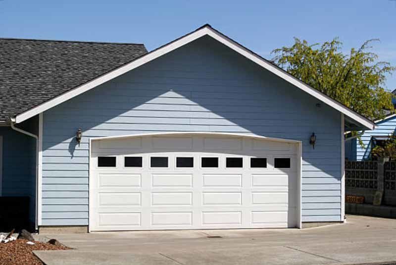 home with white garage door with windows