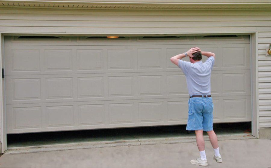 man standing outside of broken garage