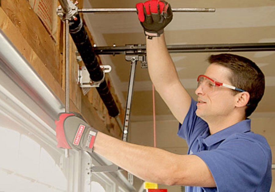 garage door repairman fixing door