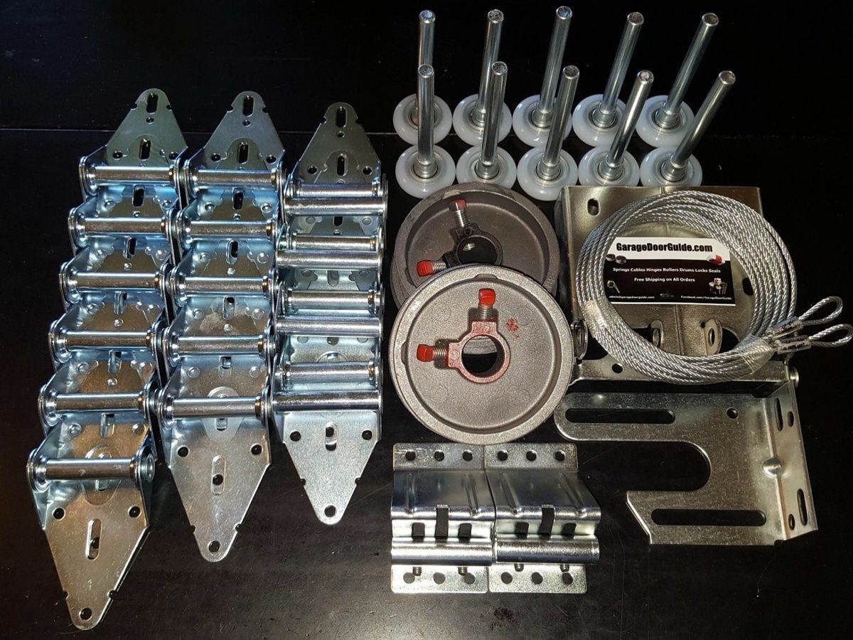 Garage door parts including rollers, hinges, cables, and hardware used for repair and maintenance